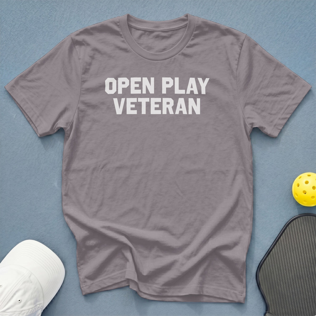 A gray crewneck t-shirt with the white text OPEN PLAY VETERAN centered on the chest.