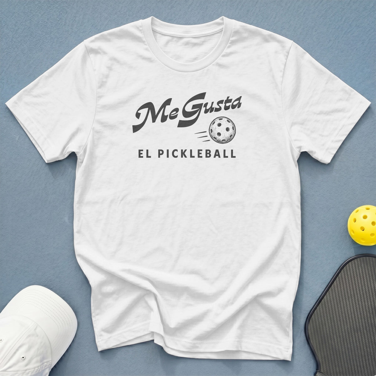 White t-shirt with "Me Gusta El Pickleball" and pickleball graphic.
