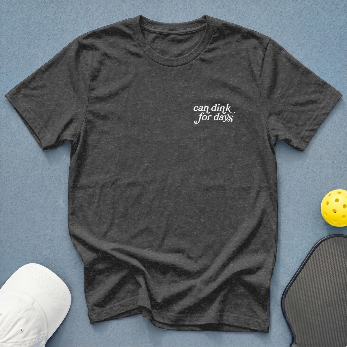 Dark grey t-shirt with white text "can dink for days" near collar.
