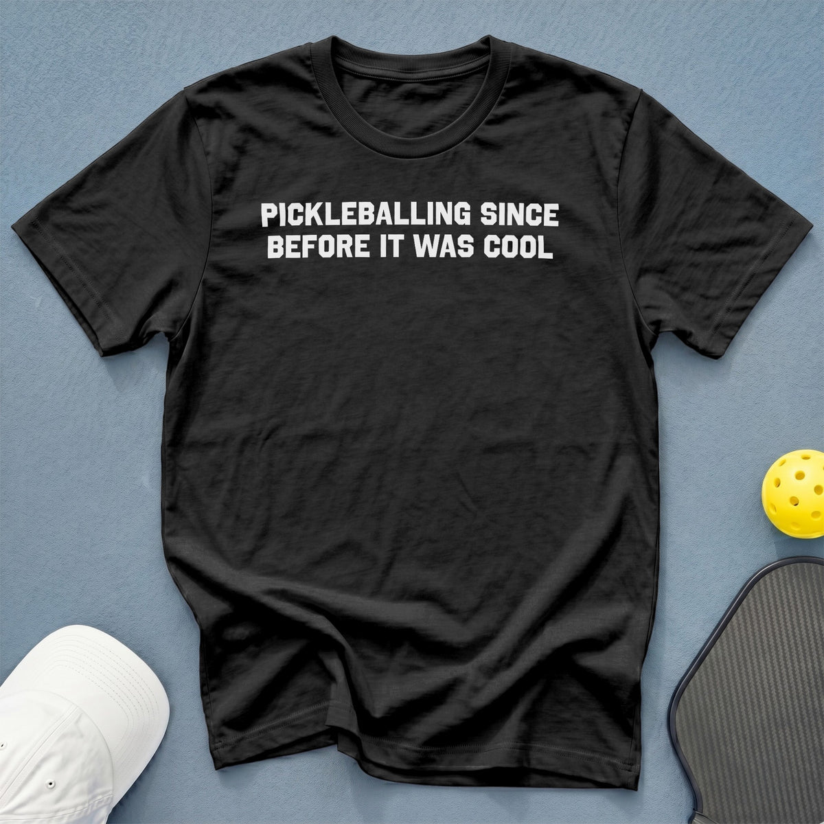 Black t-shirt with white text "PICKLEBALLING SINCE BEFORE IT WAS COOL."