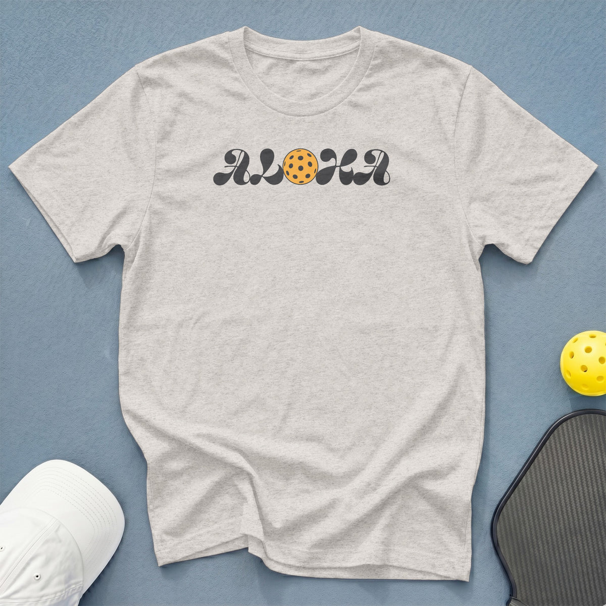 Light grey t-shirt with "ALOHA" text and pickleball graphic.