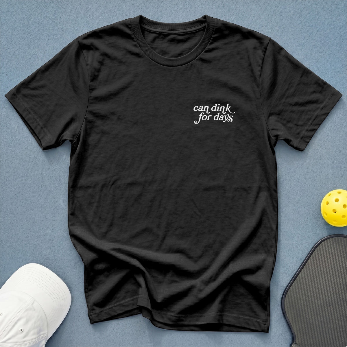 Black t-shirt with white text "can dink for days" on the chest.