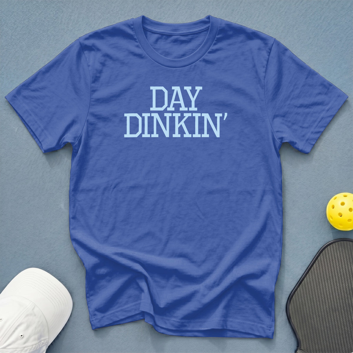 Blue t-shirt with light blue text reading "DAY DINKIN'"