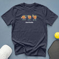 Dark t-shirt with three cartoon peaches playing pickleball and the text "Just Peachy".