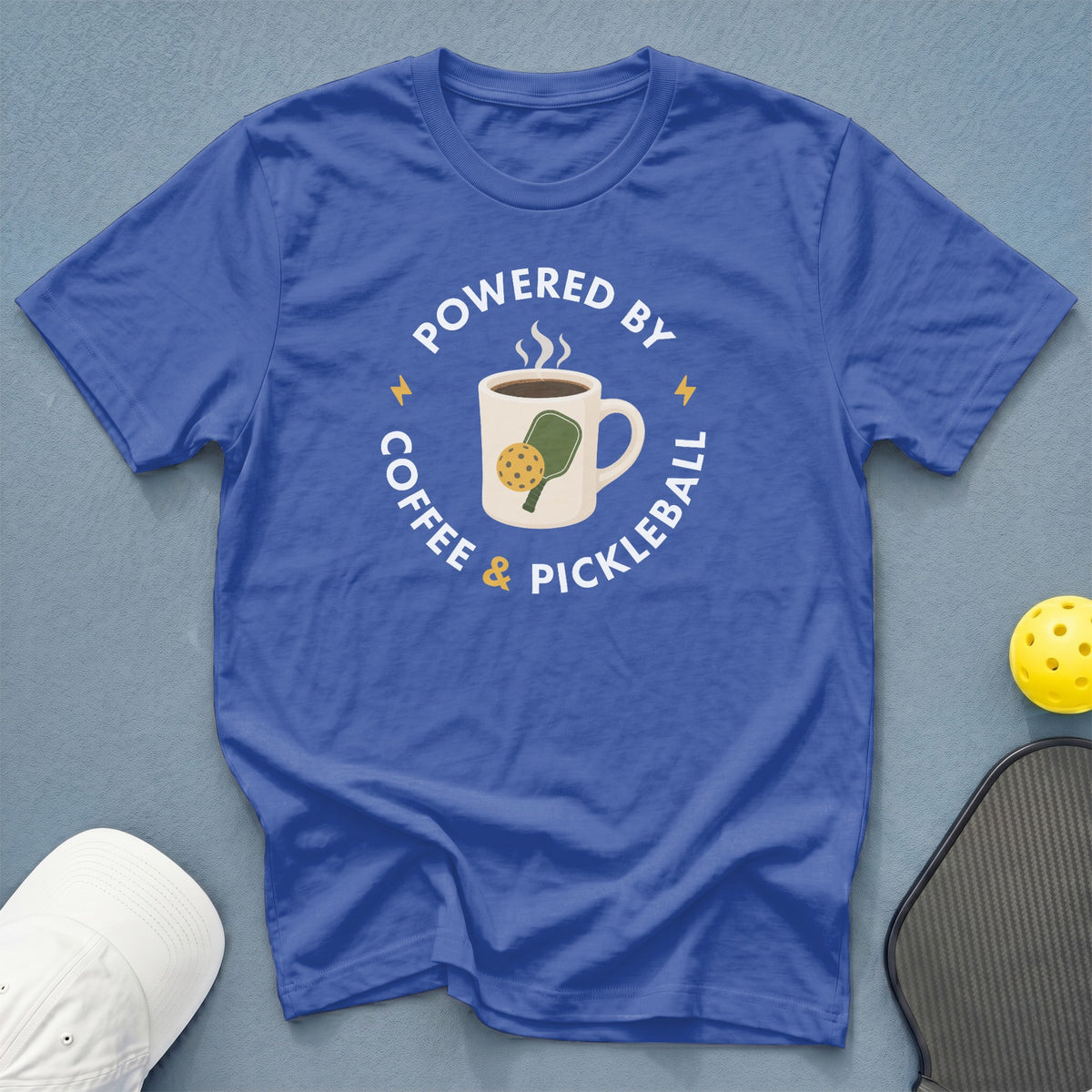 Blue t-shirt with "Powered by Coffee & Pickleball" text and graphics.