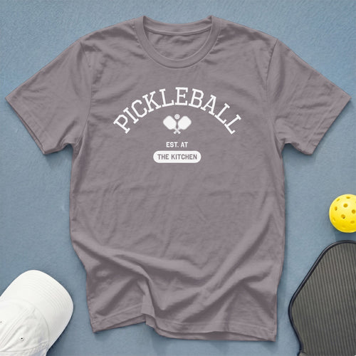 Gray t-shirt with "Pickleball Est. At The Kitchen" text and pickleball paddles graphic.