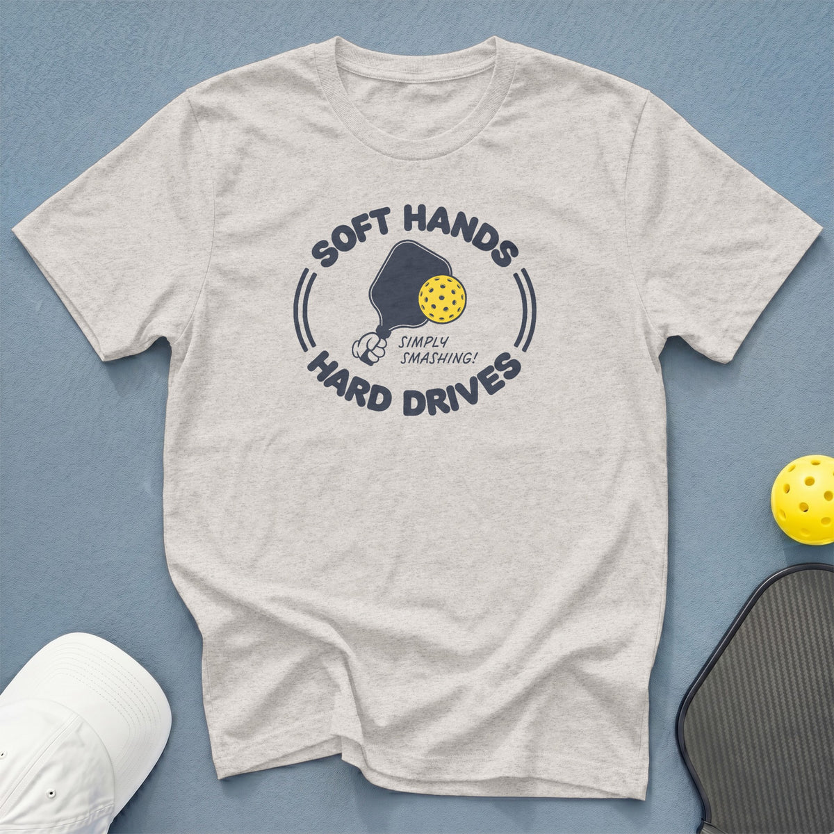 Light grey t-shirt with pickleball graphic: "Soft Hands, Hard Drives, Simply Smashing!"
