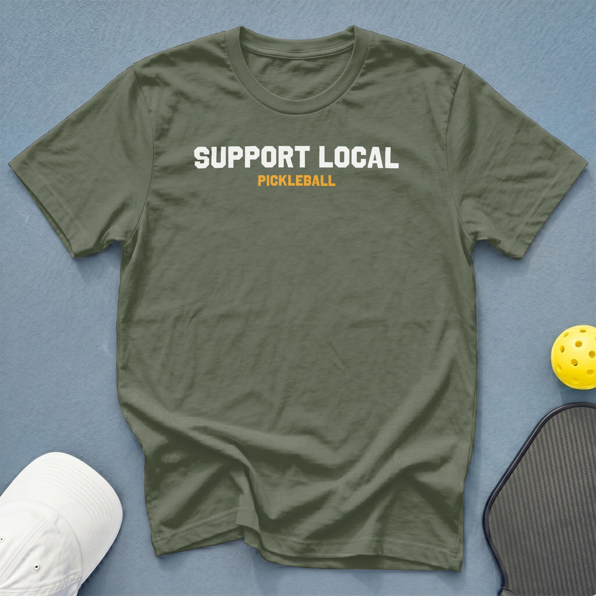 Olive green t-shirt with white "SUPPORT LOCAL" and orange "PICKLEBALL" text.