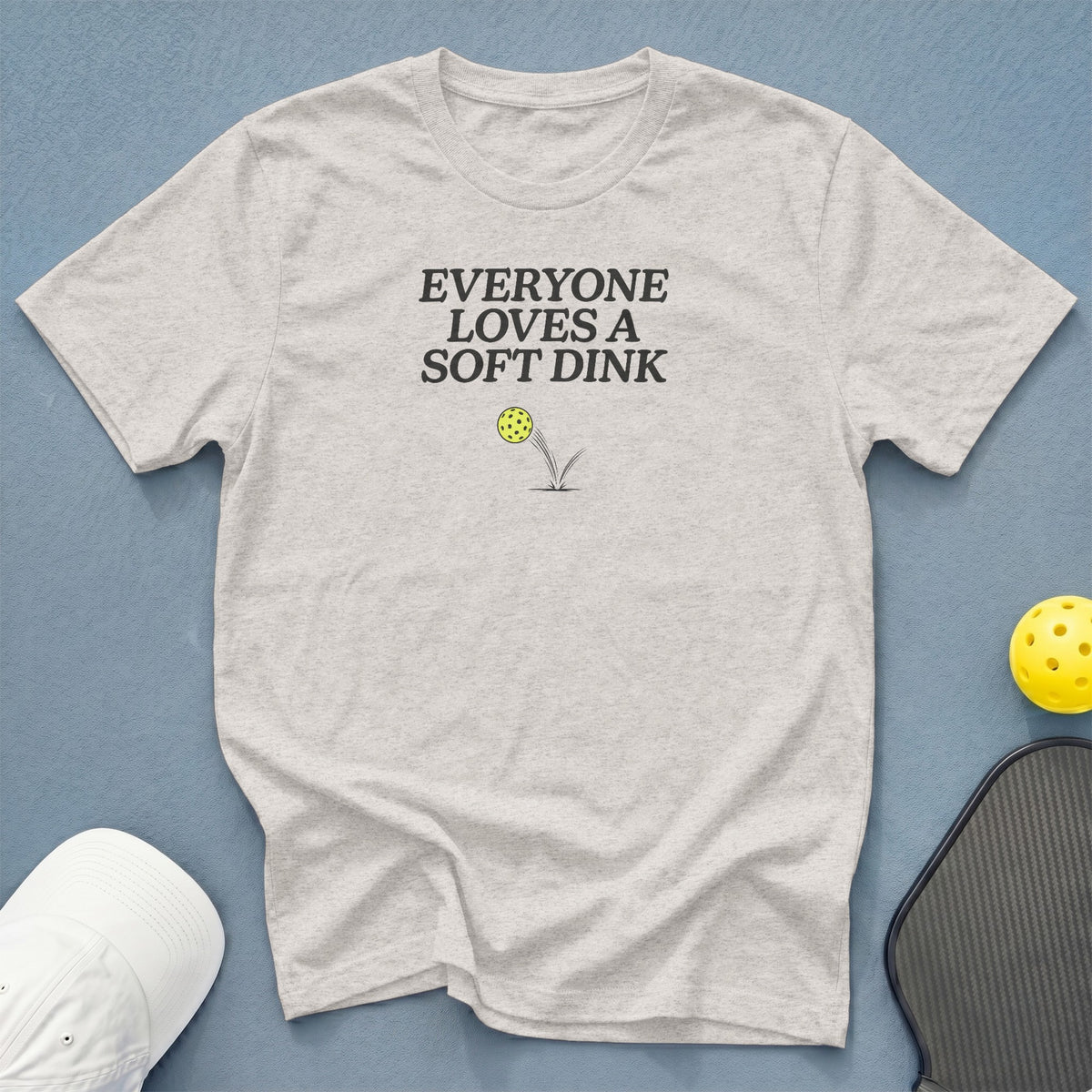 Light grey t-shirt with "EVERYONE LOVES A SOFT DINK" text and pickleball graphic.