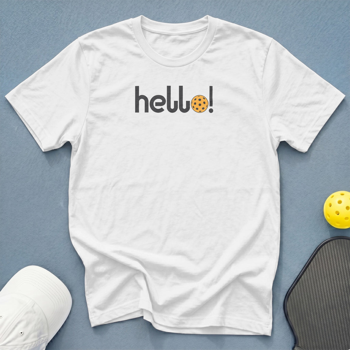 White t-shirt with "hello!" text and a pickleball graphic.