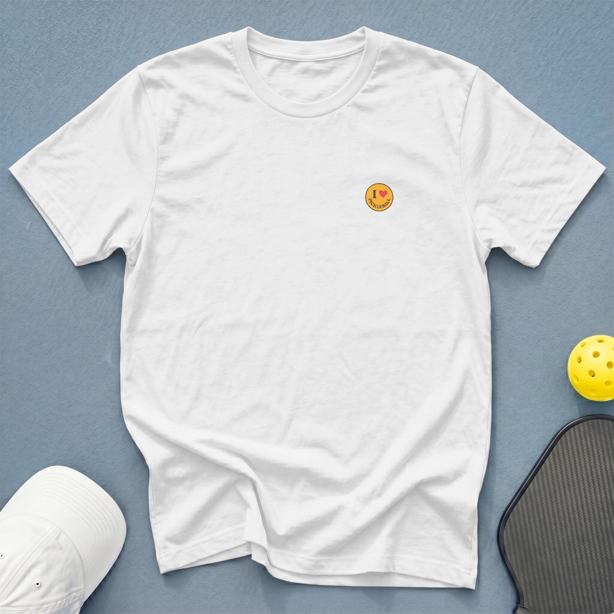 White t-shirt with embroidered "I love Pickleball" graphic, pickleball paddle, and ball.