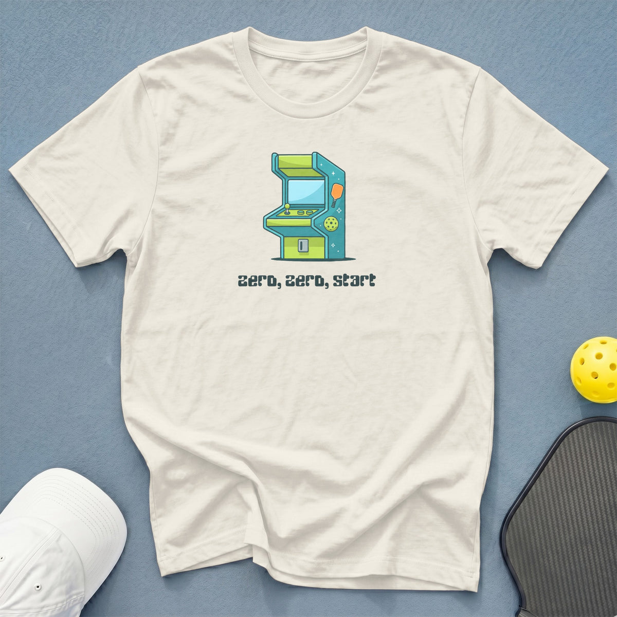 Cream t-shirt with cartoon arcade machine graphic and text "zero, zero, start".