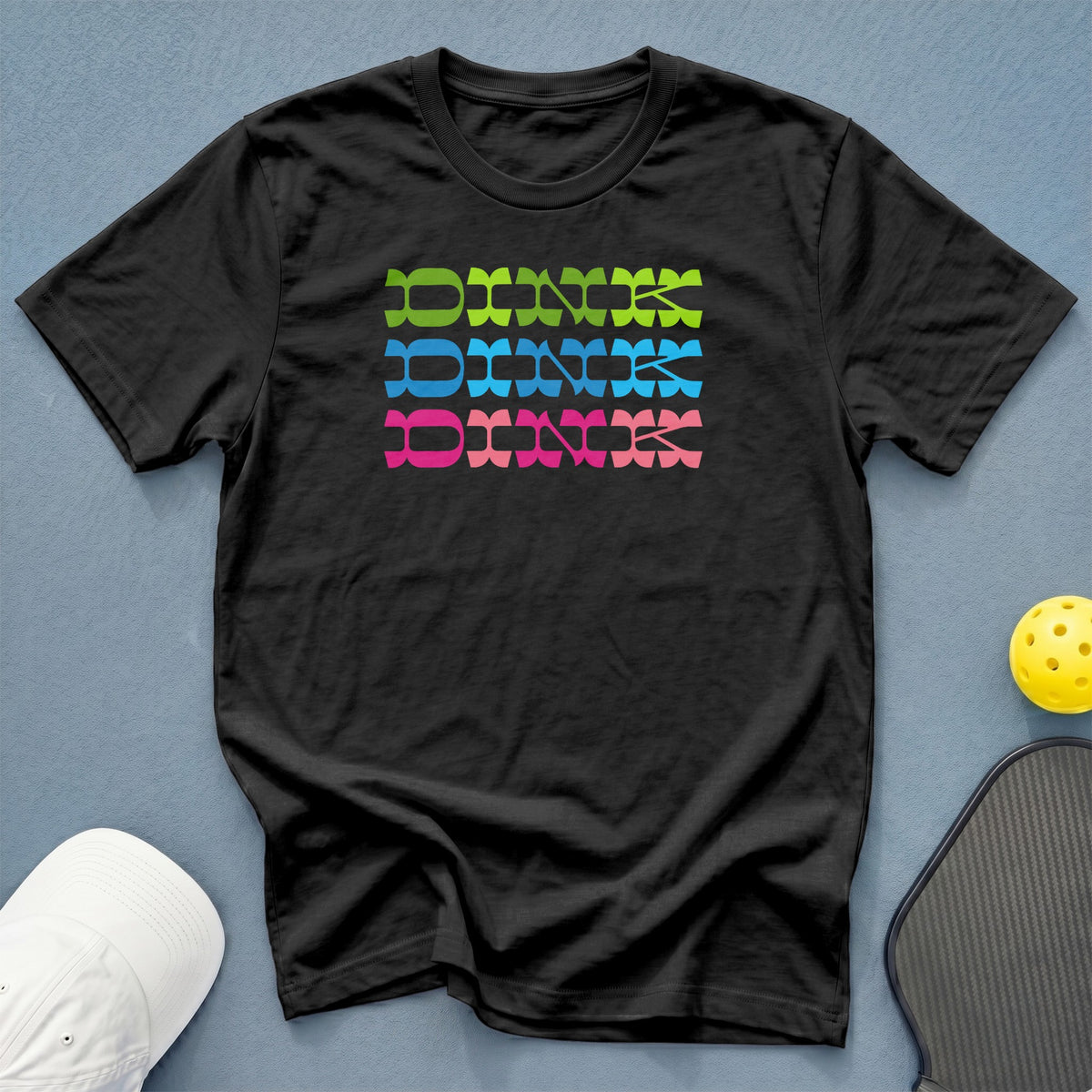 Black t-shirt with stacked "DINK" text in green, blue, and pink.