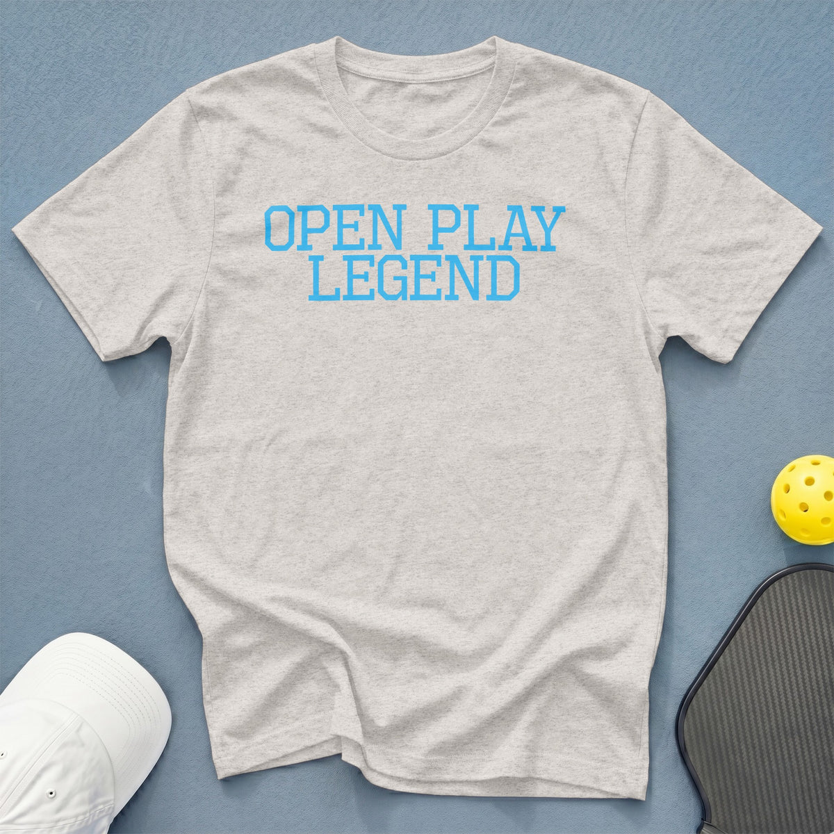 Light grey t-shirt with blue "OPEN PLAY LEGEND" text.