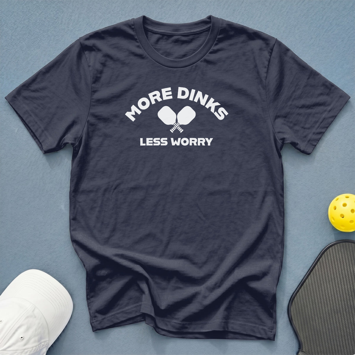 Dark t-shirt with "MORE DINKS LESS WORRY" and pickleball paddles graphic.