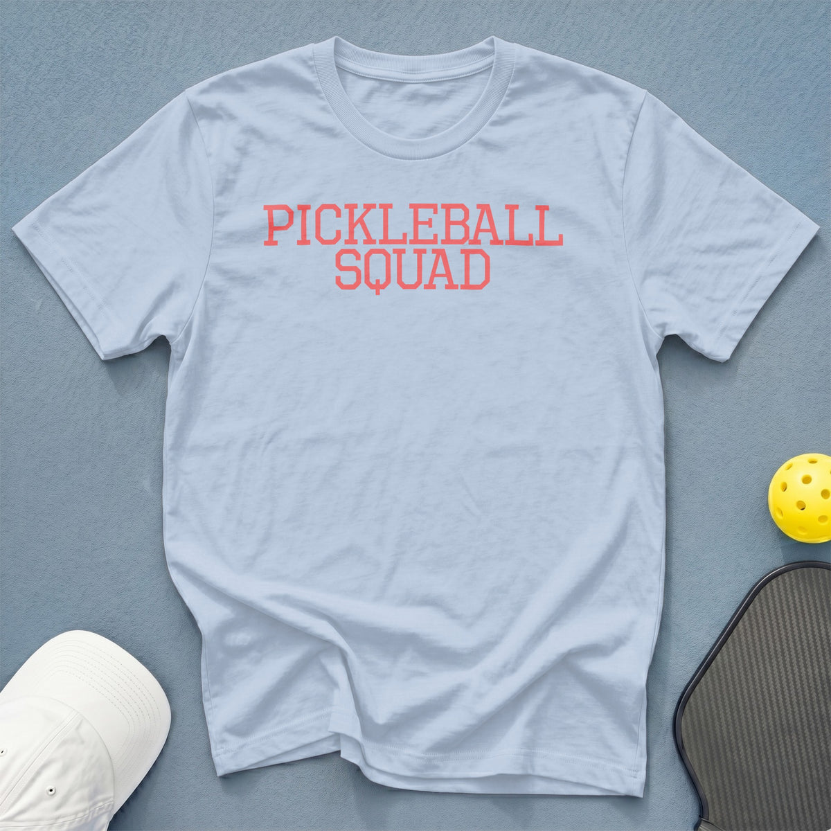 Light blue t-shirt with "PICKLEBALL SQUAD" in coral lettering.