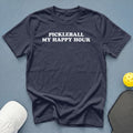 Navy t-shirt with "Pickleball My Happy Hour" text, pickleball, and paddle.