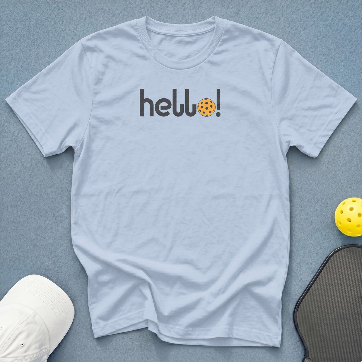 Light blue t-shirt with "hello!" text and pickleball graphic.