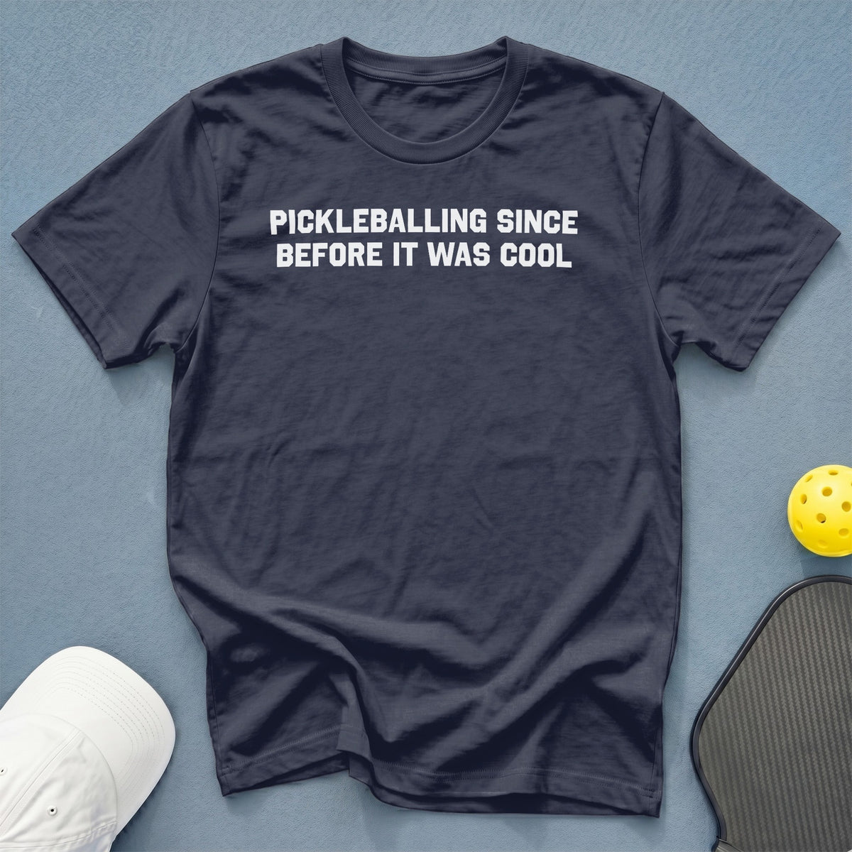 Dark t-shirt with white text: PICKLEBALLING SINCE BEFORE IT WAS COOL.