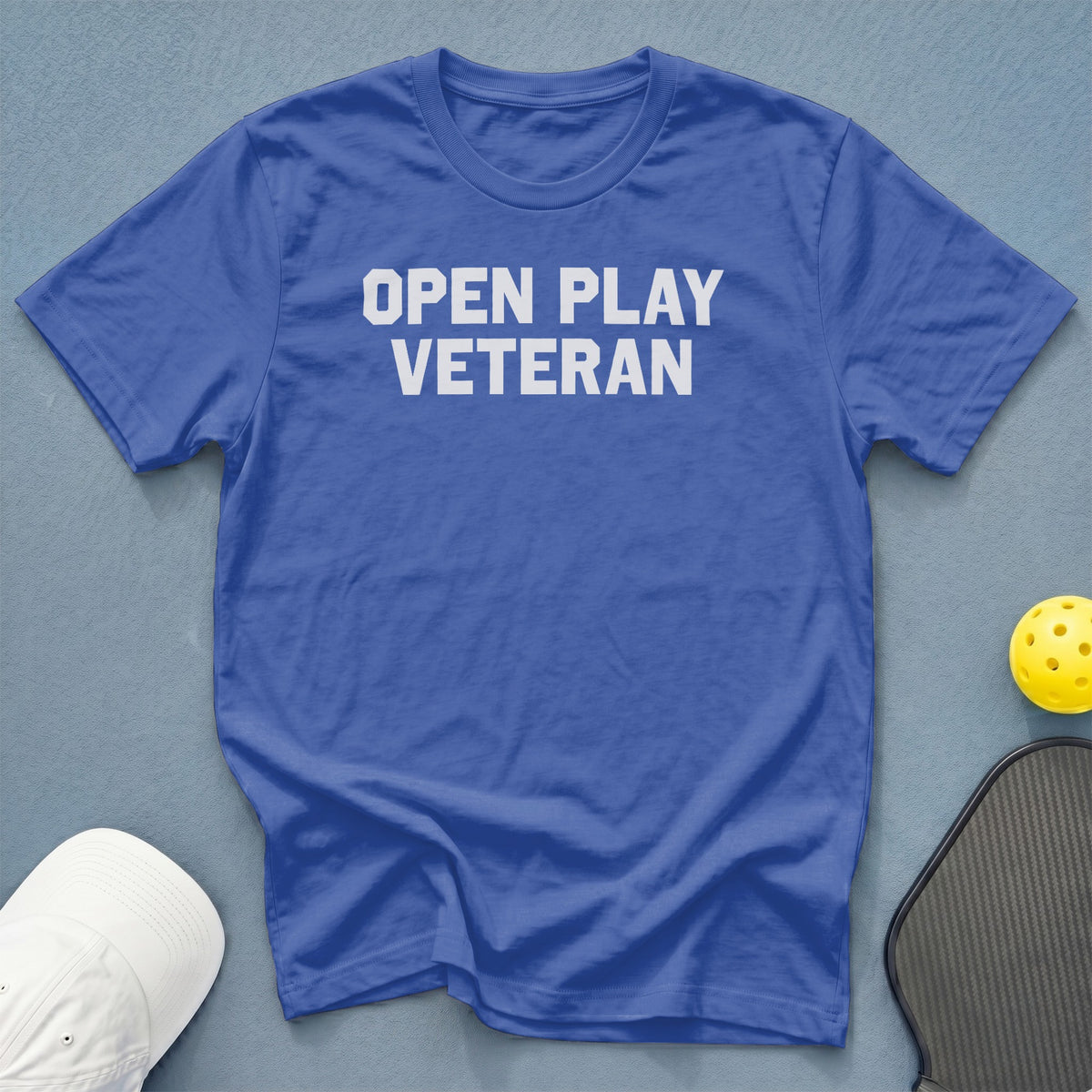 Blue t-shirt with "OPEN PLAY VETERAN" in white text.
