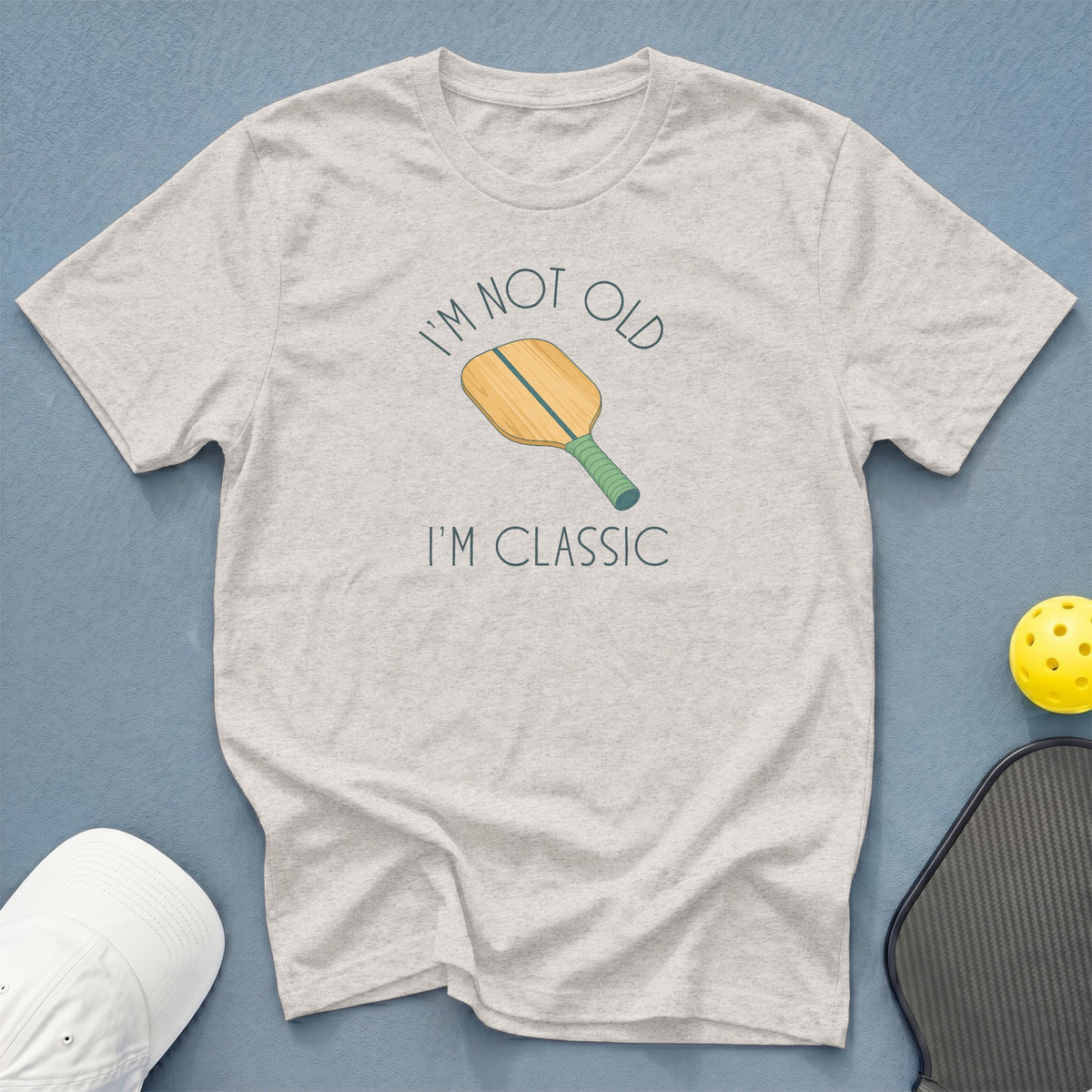 Light grey t-shirt with pickleball paddle graphic and text "I'm Not Old I'm Classic".