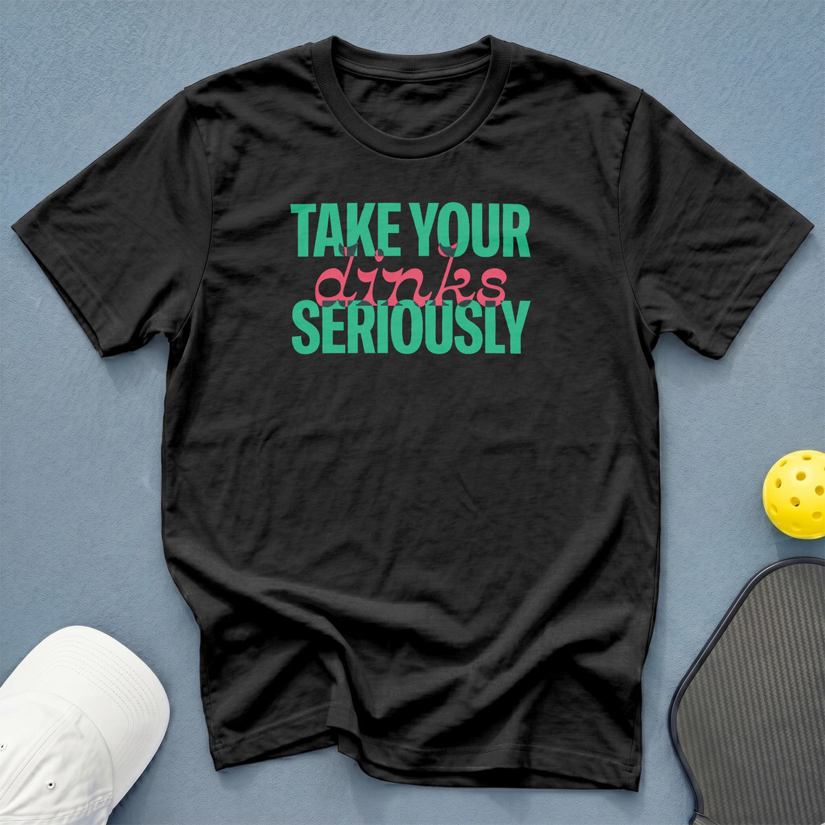 Black t-shirt with "Take Your Dinks Seriously" text in teal and pink.