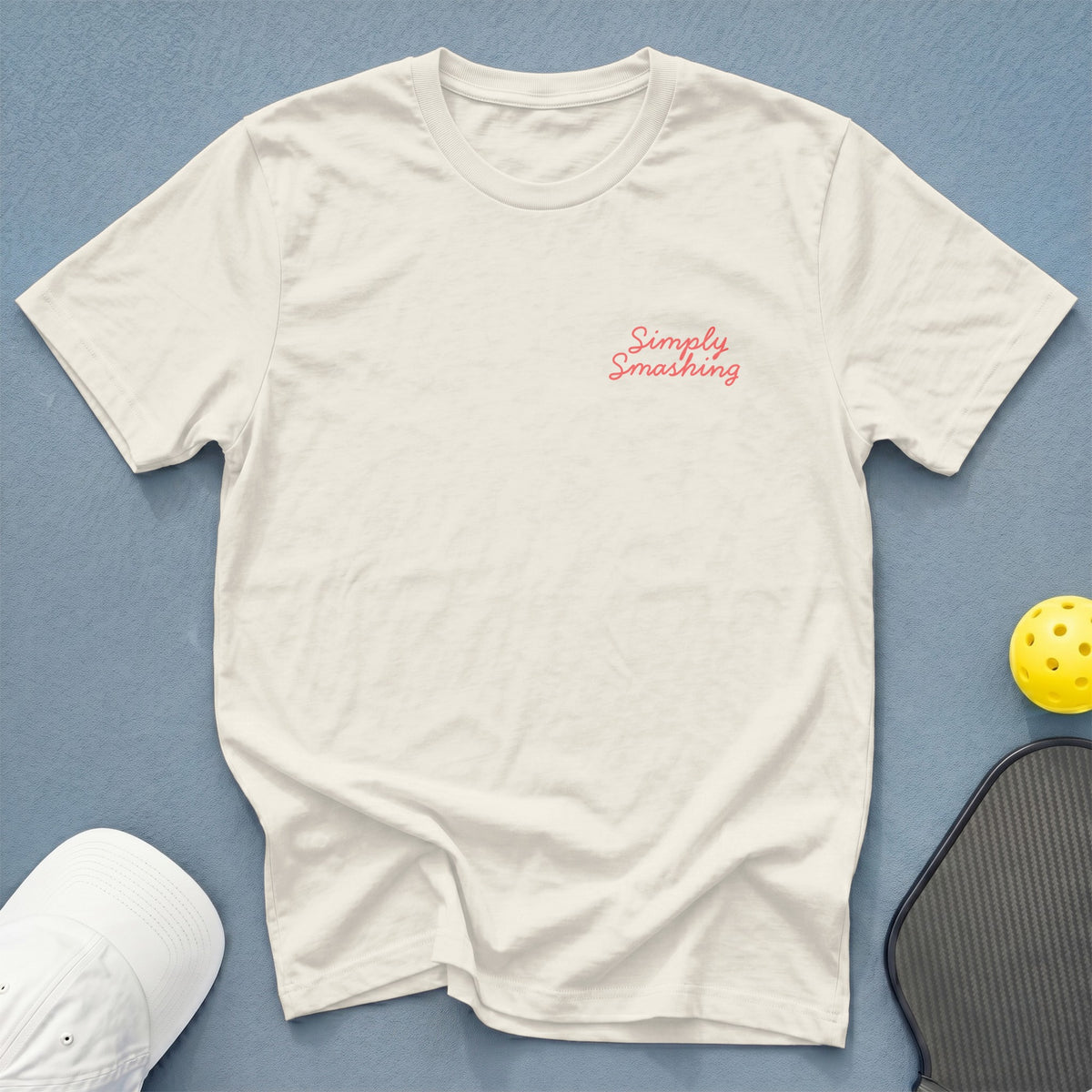 Cream t-shirt with pink "Simply Smashing" text on left chest