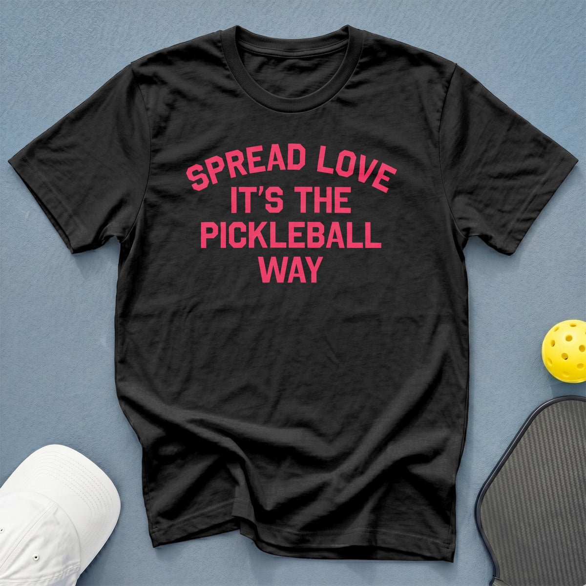 Black t-shirt with pink text "SPREAD LOVE IT'S THE PICKLEBALL WAY".