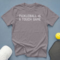 Gray t-shirt with white text "PICKLEBALL IS A TOUCH GAME".