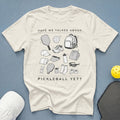 Cream t-shirt with pickleball gear graphic and text "HAVE WE TALKED ABOUT PICKLEBALL YET?".