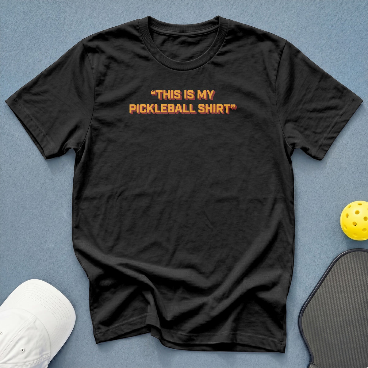 Black t-shirt with orange text that reads "THIS IS MY PICKLEBALL SHIRT".