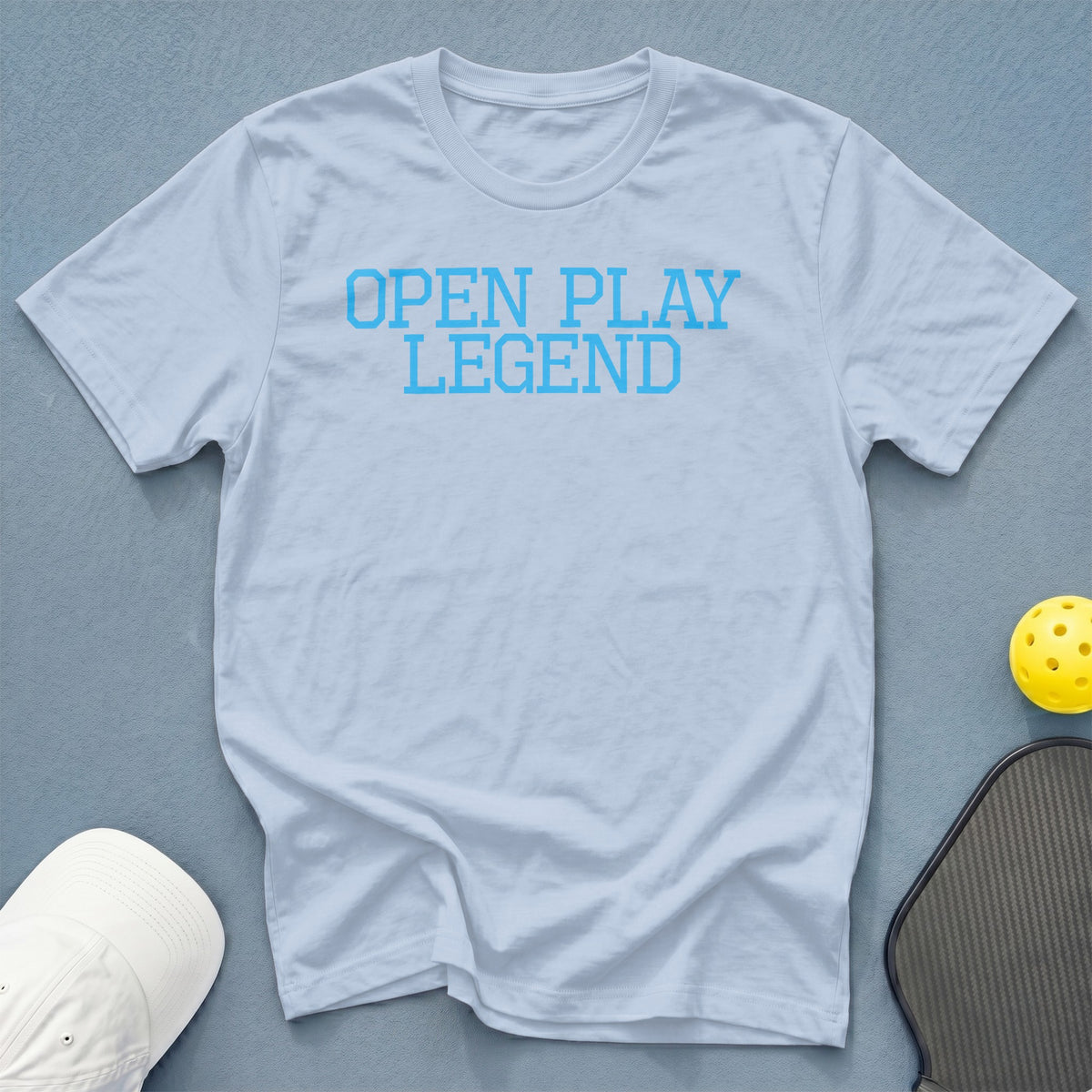 Light blue t-shirt with "OPEN PLAY LEGEND" in blue collegiate font.