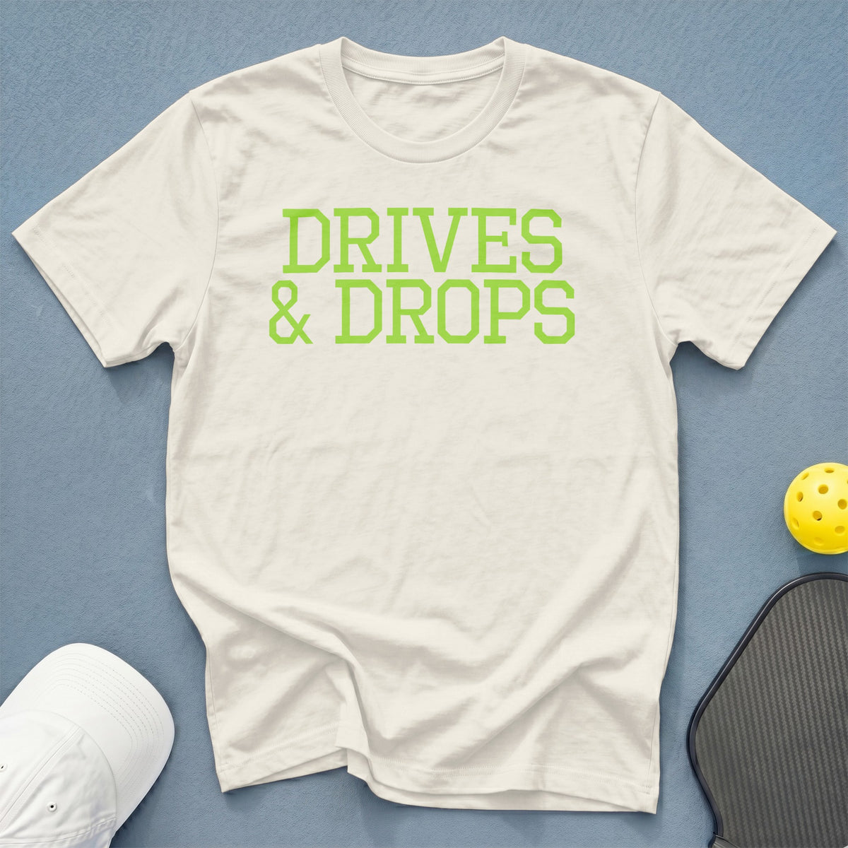 White t-shirt with "DRIVES & DROPS" in lime green text.
