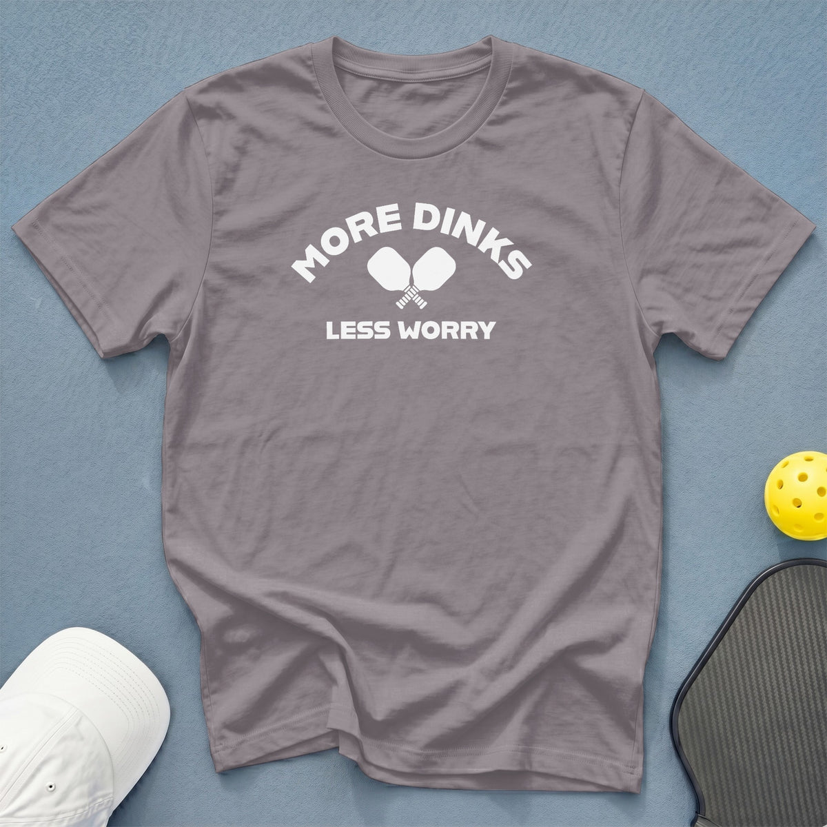 Grey t-shirt with "MORE DINKS LESS WORRY" and crossed pickleball paddles.
