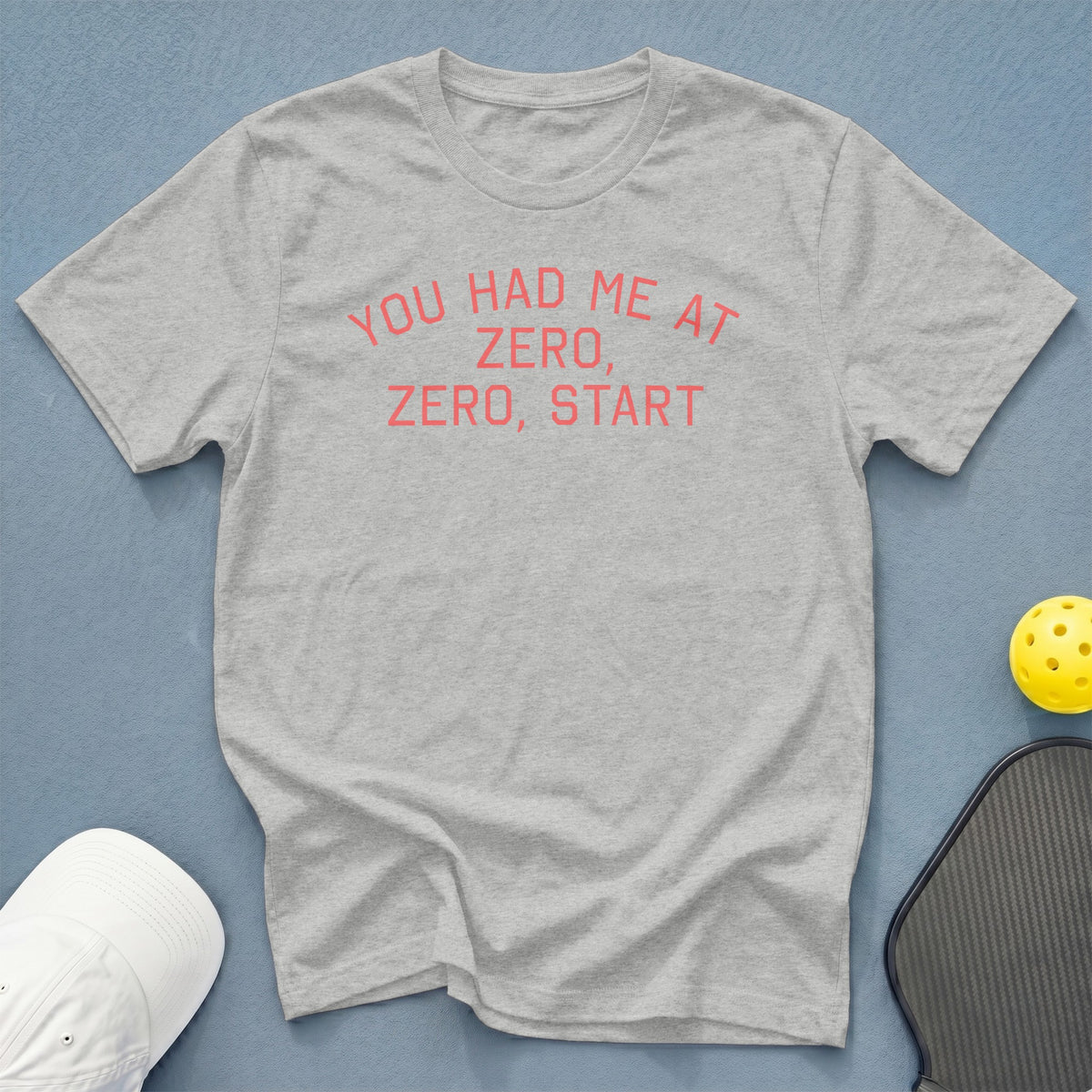 Grey t-shirt with coral text: "You Had Me At Zero, Zero, Start."