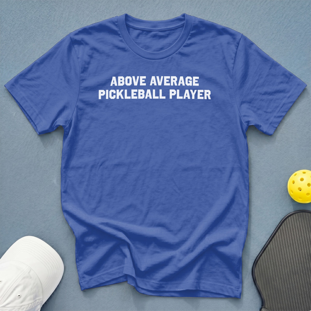 Royal blue t-shirt with "ABOVE AVERAGE PICKLEBALL PLAYER" in white text.
